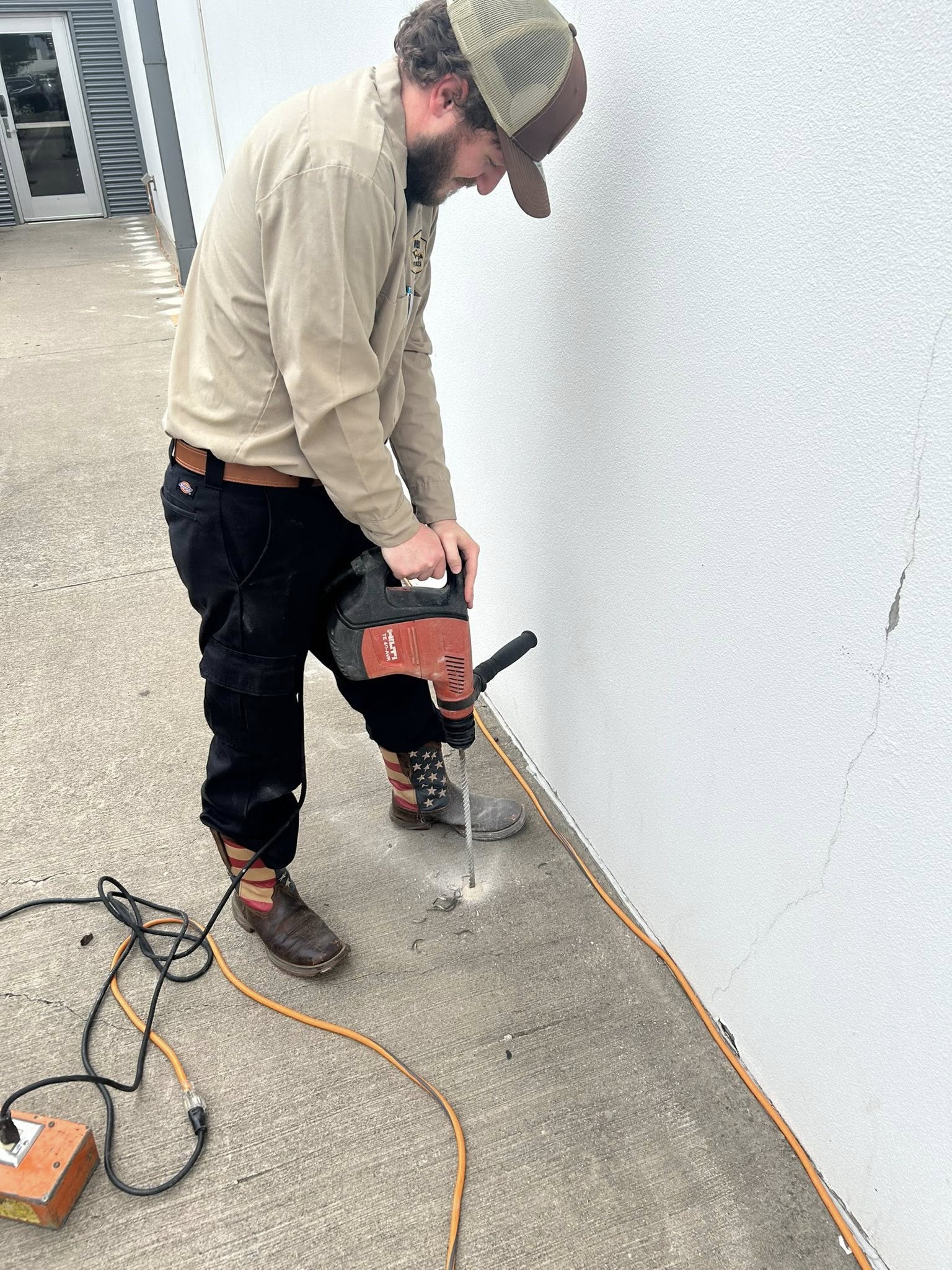 Employee drilling into the ground