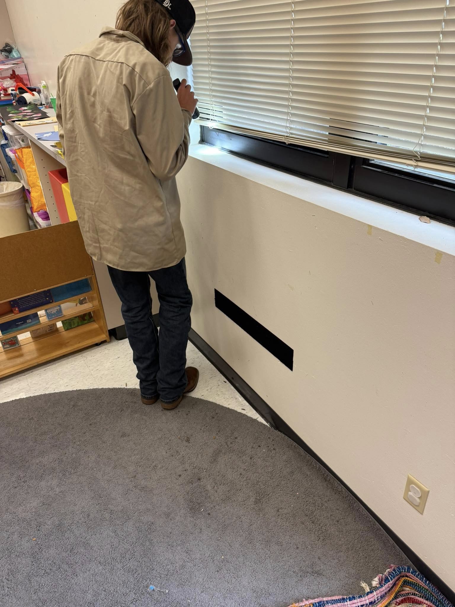 Employee examining inside building for pests