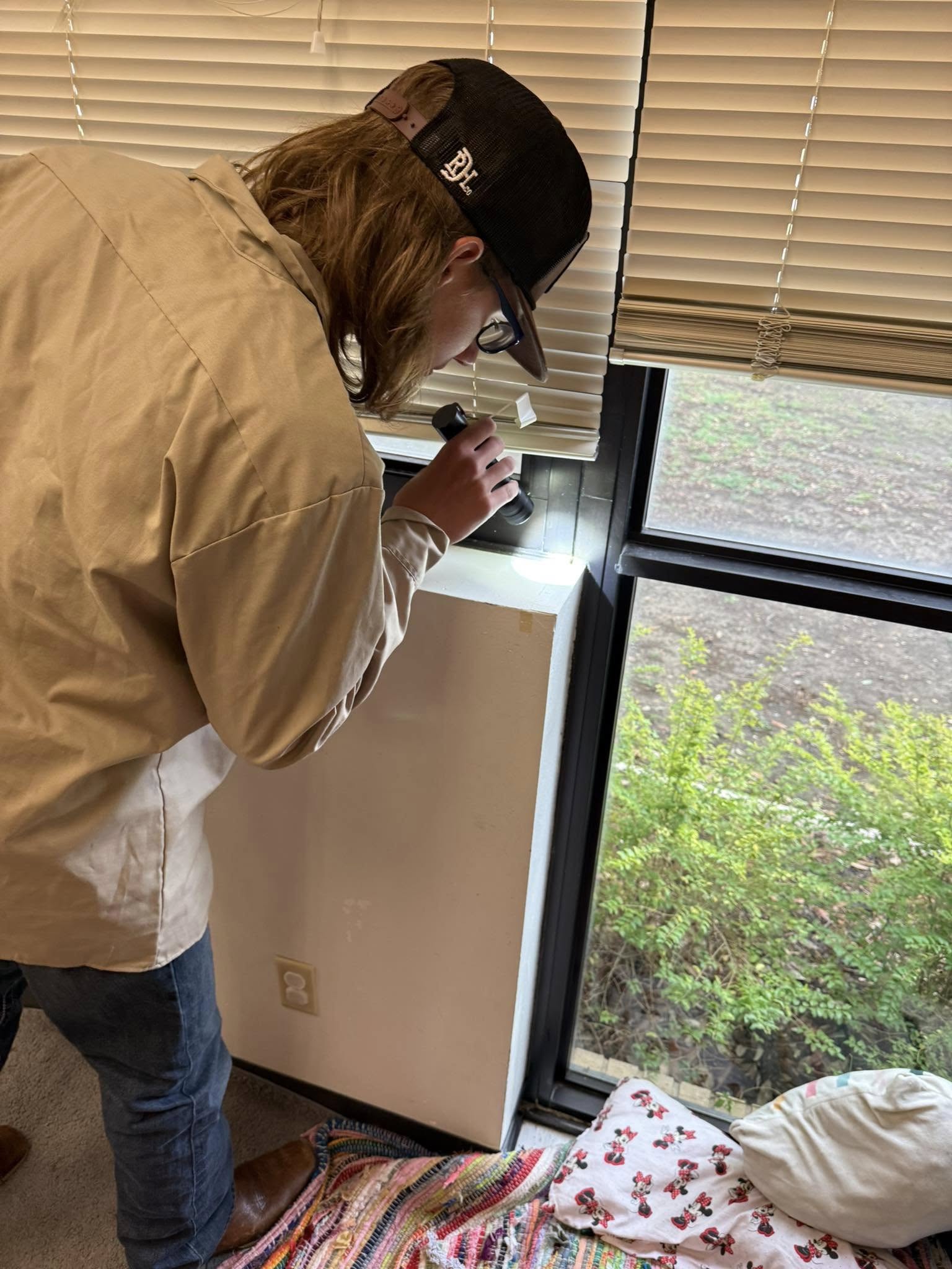 Employee performing careful examination for pest in commercial building