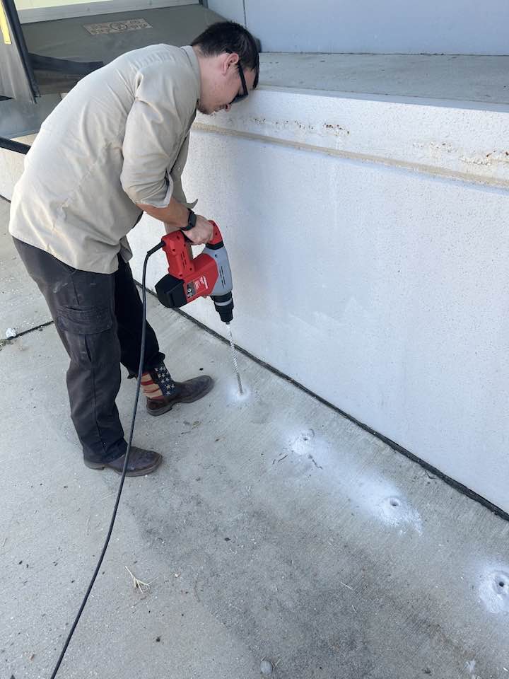 Termite control by drilling holes in concrete